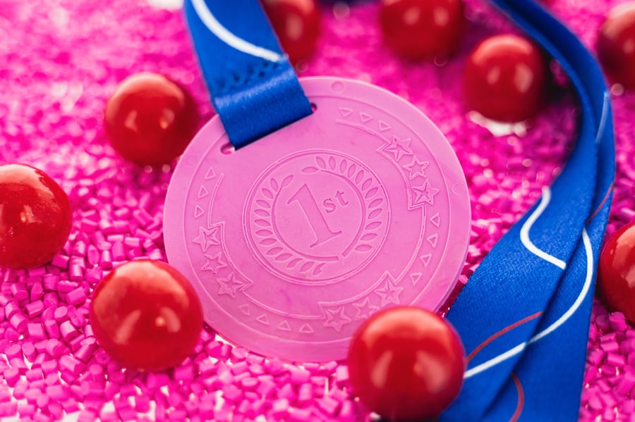 A photograph of a gum medal, surrounded by bubble gum.