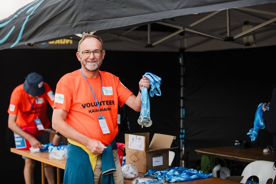 Image of a Round The Bays volunteer with custom medals.