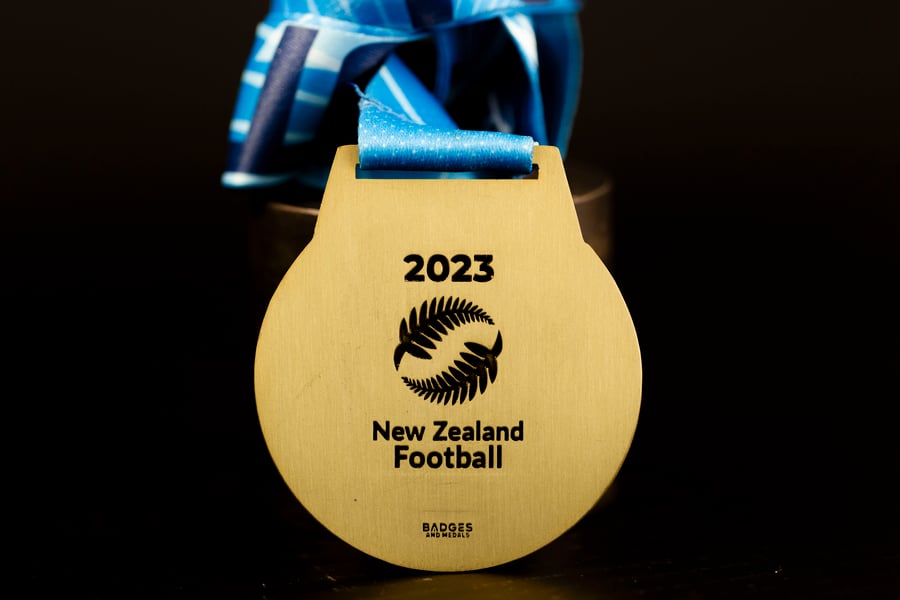 Custom New Zealand Football medal with engraving.